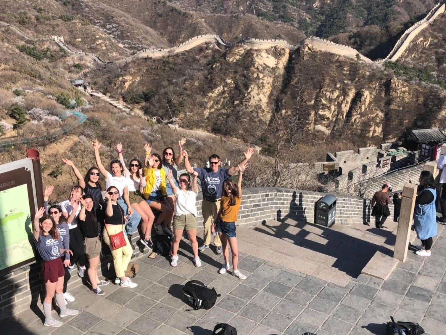 A Student Study Tour group takes a picture on top of The Great Wall of China.